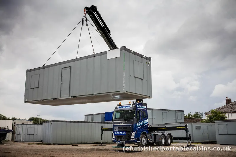 Portable cabin lifted onto a lorry by HIAB ready to move to its new site