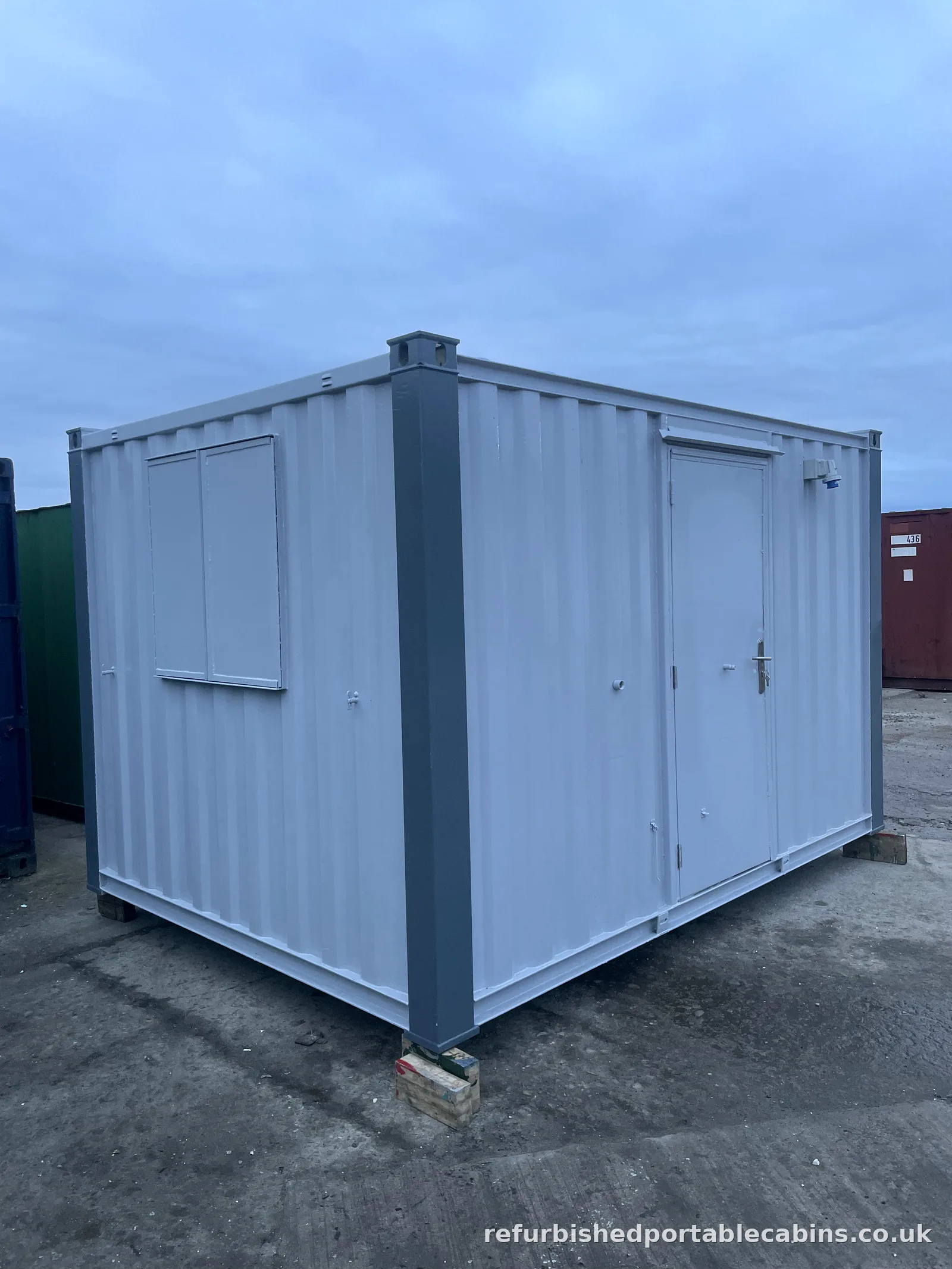 Used steel office container converted with a personnel door and window