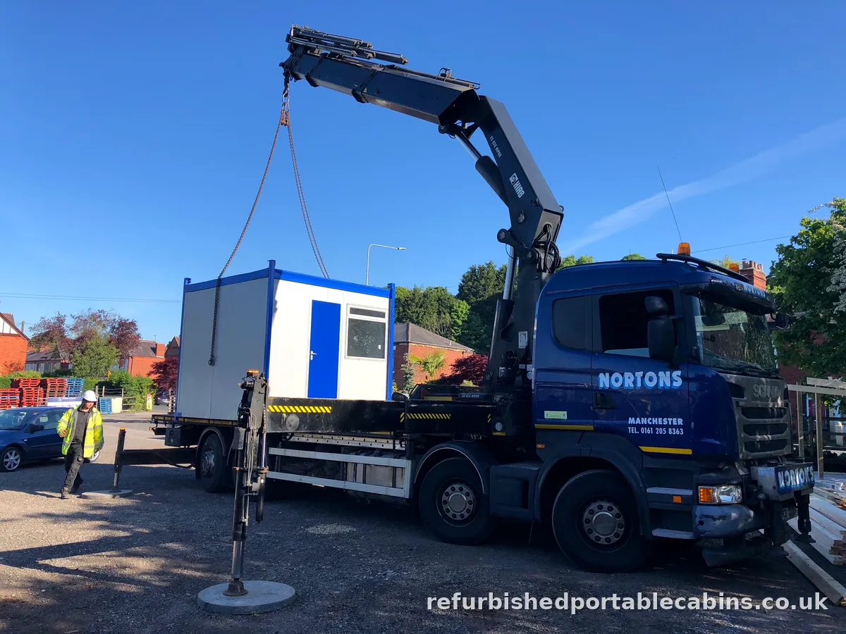 HIAB lorry lifting a refurbished portable cabin into position on site