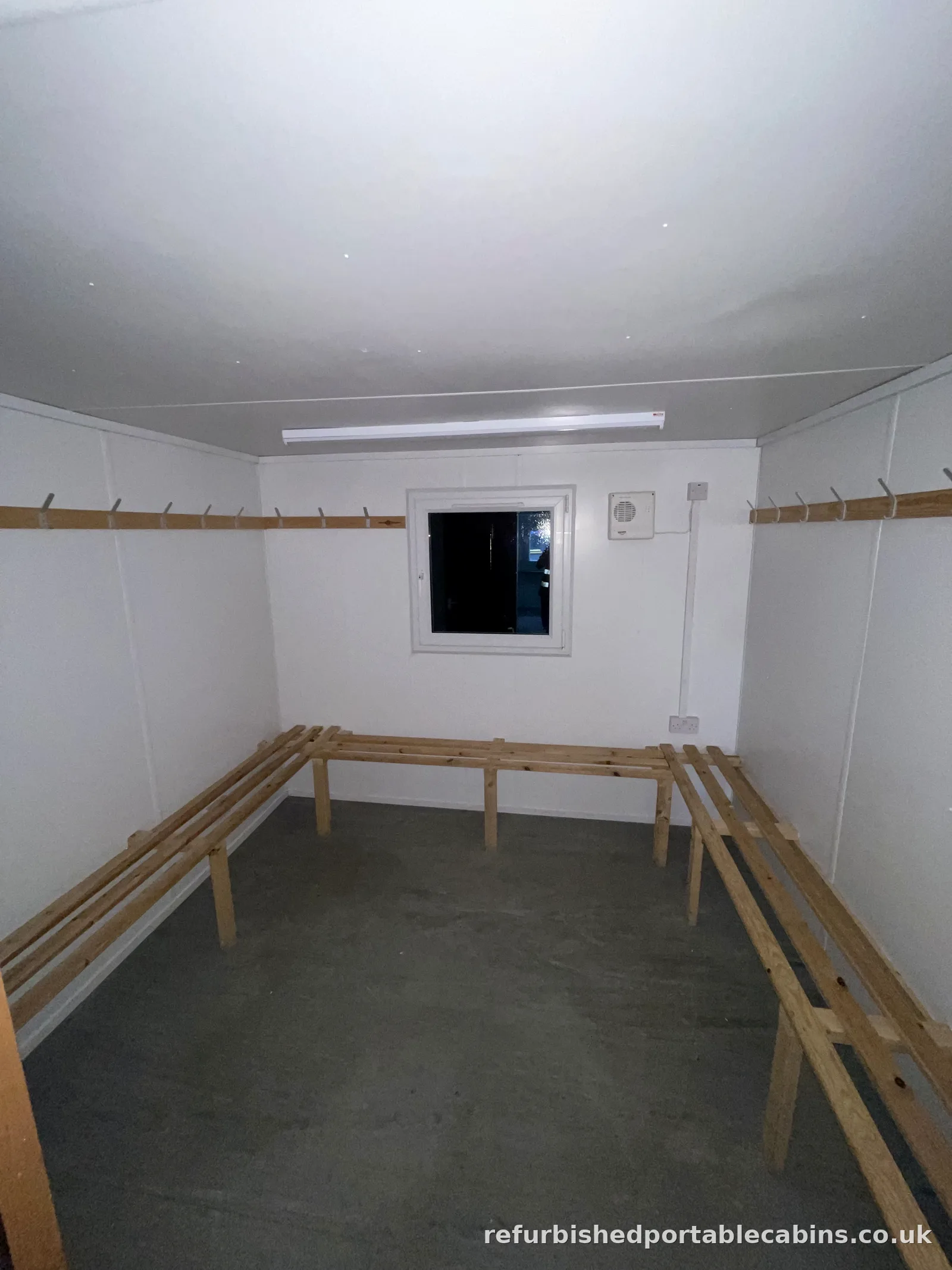 Refurbished drying room cabin with hook rails and bench seating