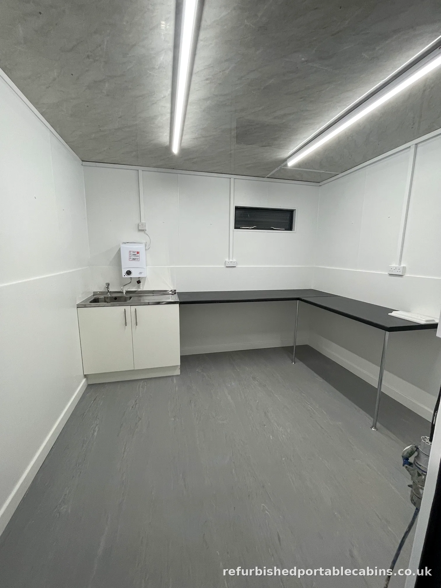 Refurbished kitchen cabin with fitted units, worktop and stainless sink