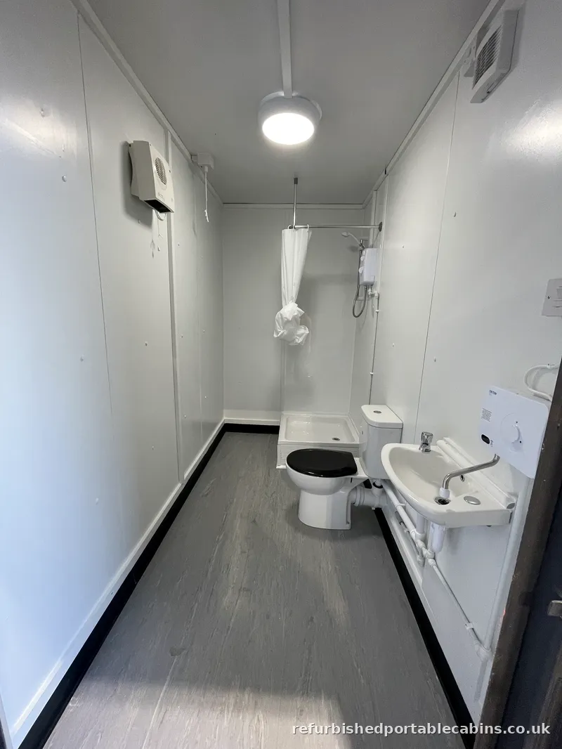 Shower, toilet and basin in a refurbished portable cabin washroom