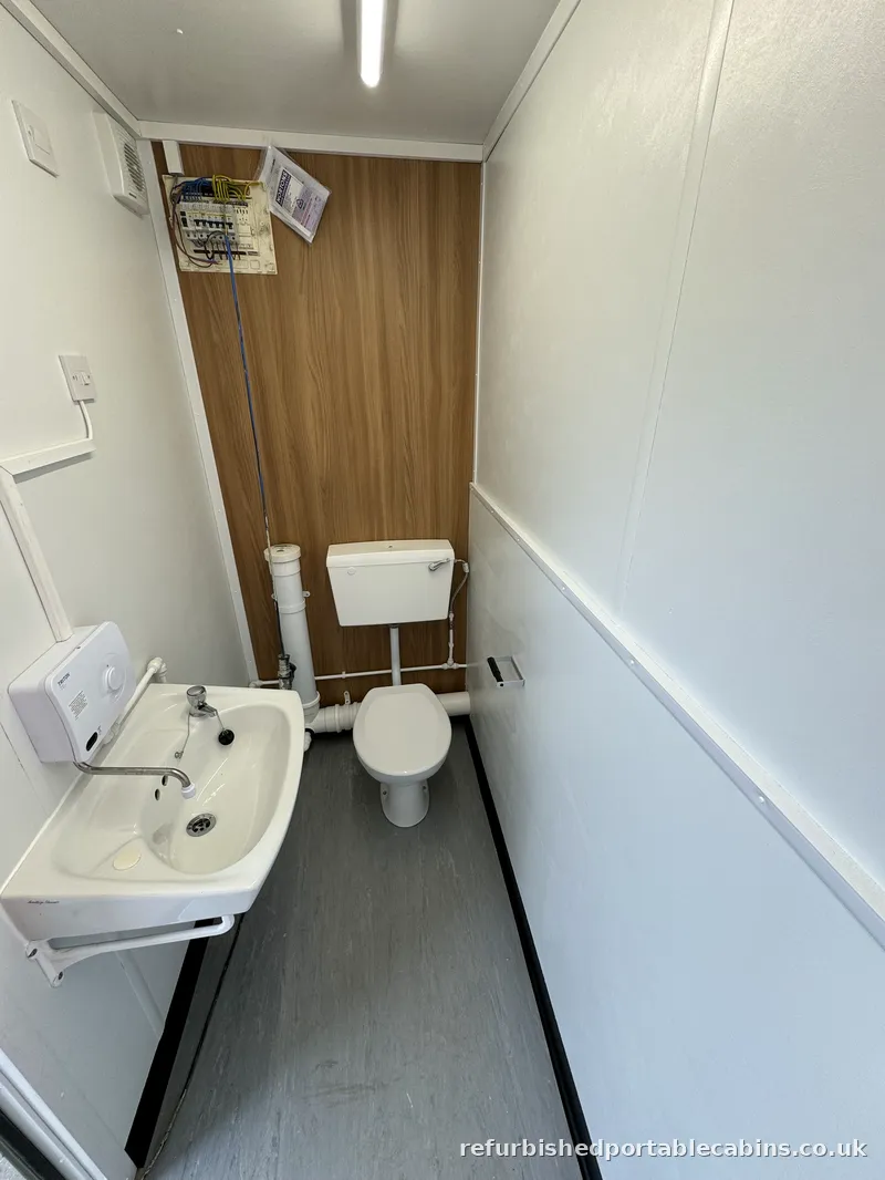Toilet and wash basin fitted in a refurbished portable cabin