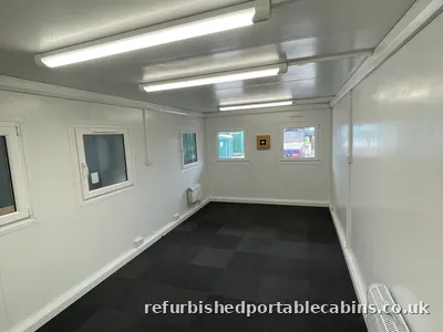 Open plan cabin office with carpet tiles and windows