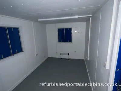 Carpeted open plan office fitted out in a refurbished portable cabin
