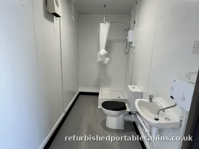 Shower, toilet and basin in a refurbished portable cabin washroom