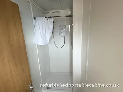 Shower enclosure fitted in a refurbished portable cabin