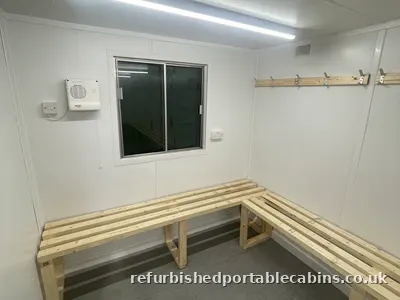 Changing room cabin with bench seating and hook rail